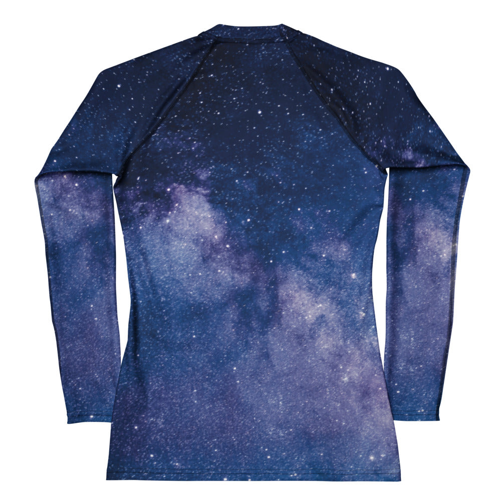 Women’s long-sleeve buttery soft rash guard with detailed galaxy print in blues and purples and upf 50+ protection