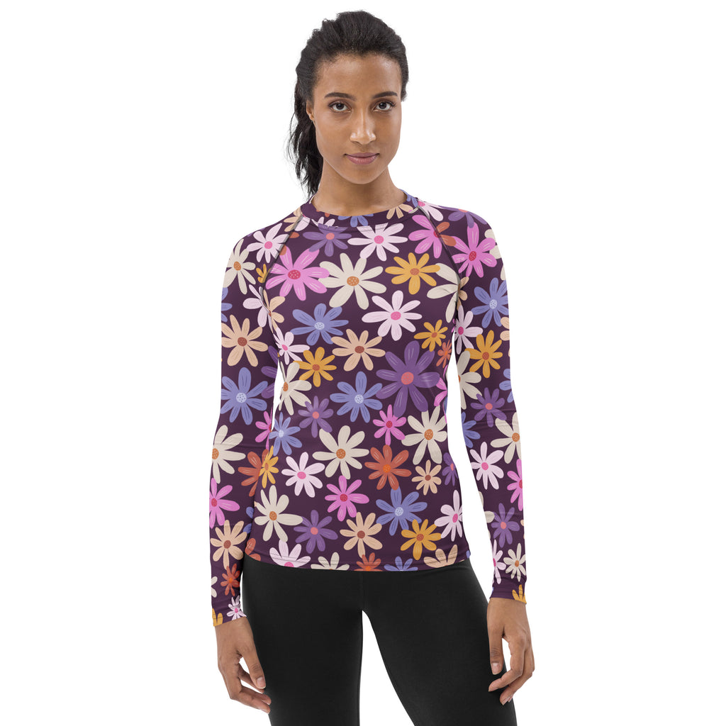 A vibrant womens retro floral long sleeve rash guard in buttery soft fabric with upf 50 plus protection on purple base