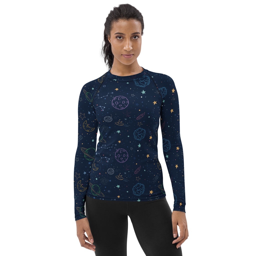 A navy blue womens long sleeve rash guard with playful pastel space print and UPF 50 plus buttery soft fabric