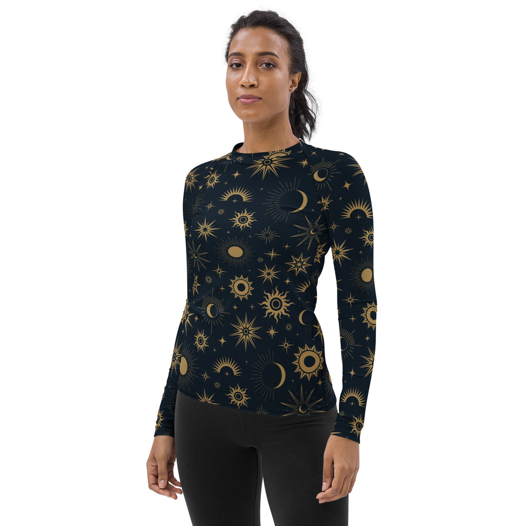 A dark navy womens long sleeve rash guard swim shirt with a gold celestial sun moon and star pattern and UPF 50+
