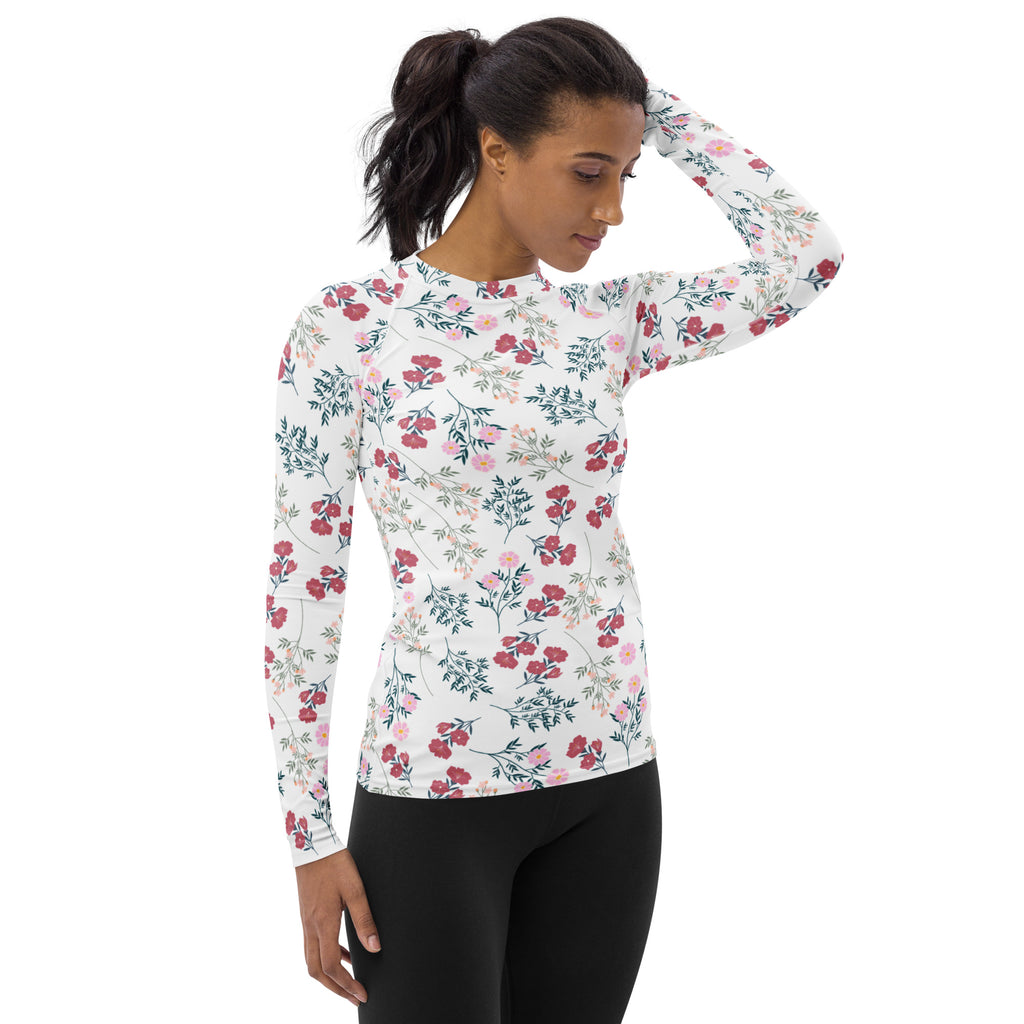 Women’s white long sleeve rash guard with a delicate pink floral pattern and UPF 50 plus buttery soft fabric