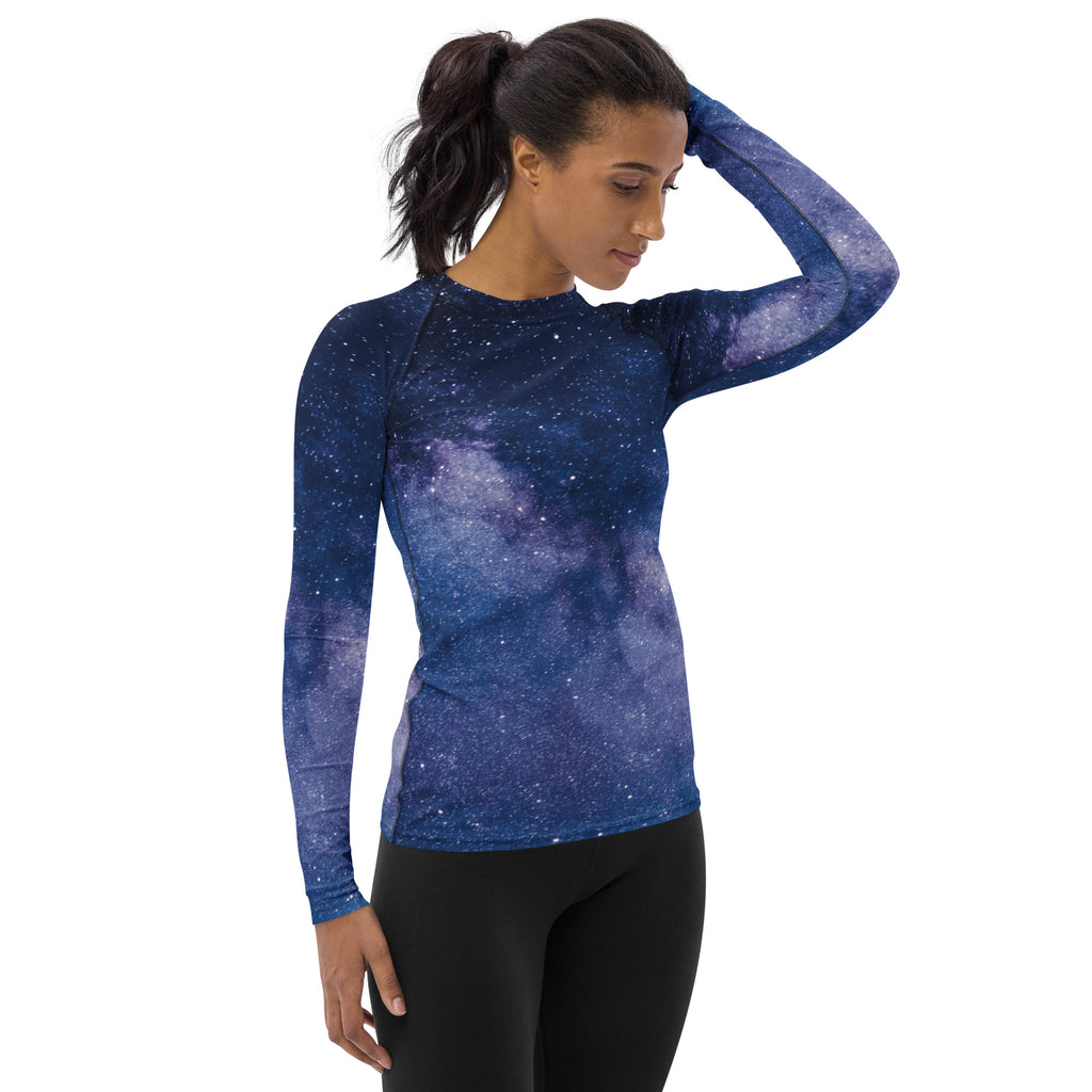 Women’s long sleeve rash guard swim shirt with deep blue and purple galaxy print and UPF 50 plus buttery soft fabric