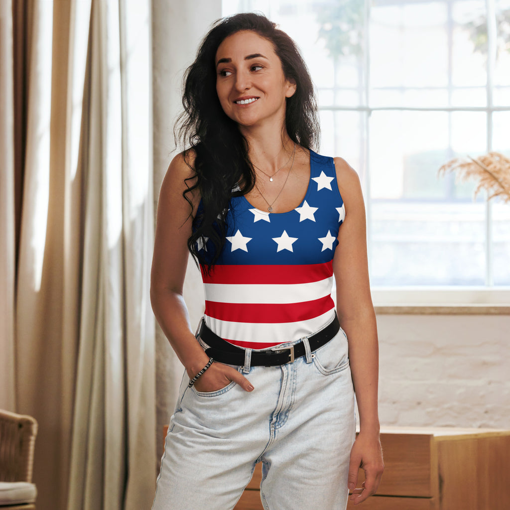 A woman wearing a women’s american flag tank top with white stars on blue and red stripes in quick drying fabric
