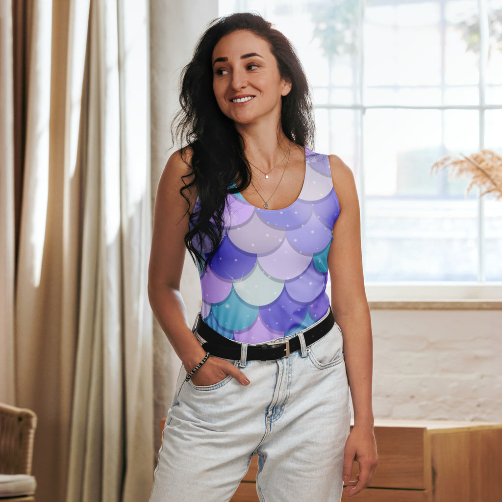 A woman wears a sleeveless purple mermaid scale tank top with quick drying buttery soft fabric and upf 50+ protection