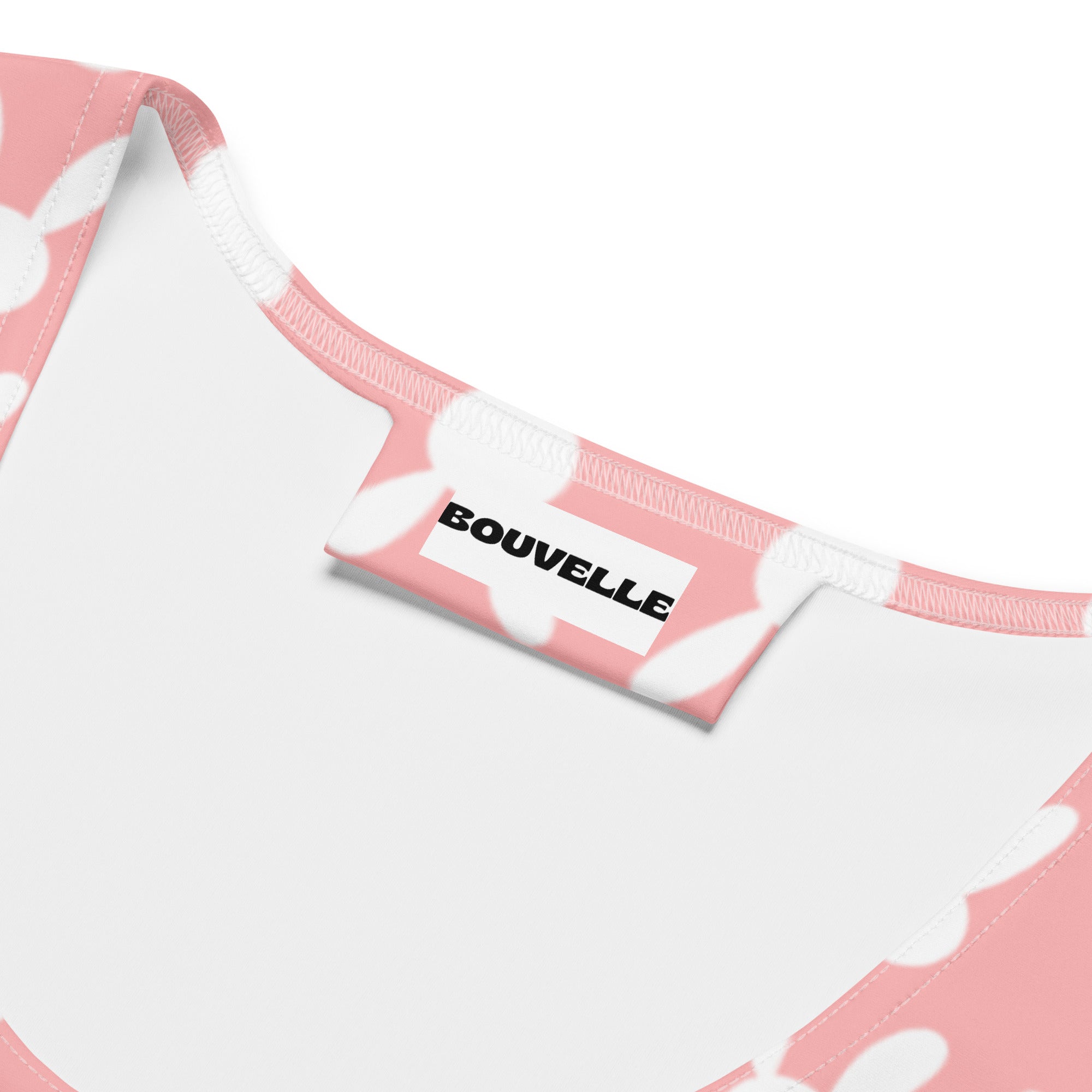 Pink and white bunny patterned garment tag with bouvelle printed on the back of a women’s pink bunny tank top