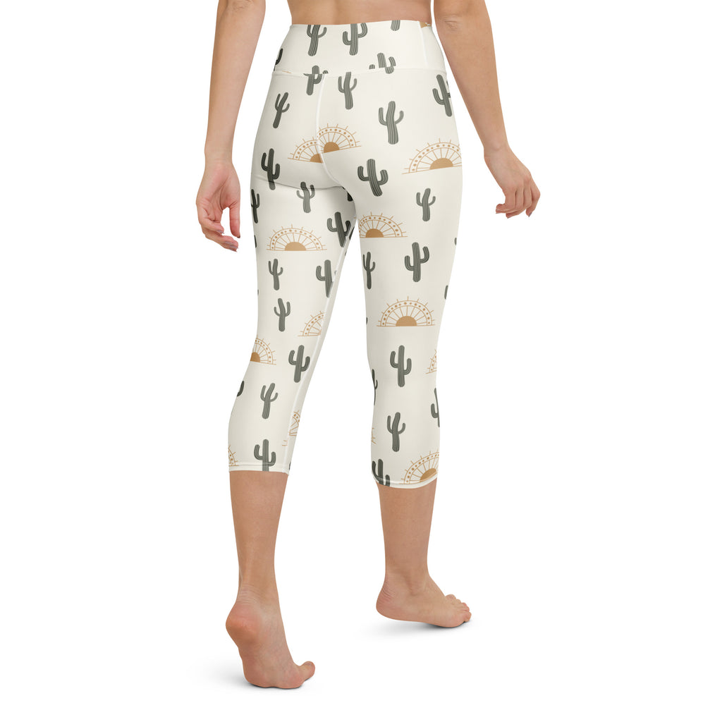Cream-colored high-rise buttery soft yoga capri leggings with gray cactus and gold sunburst moisture-wicking pattern