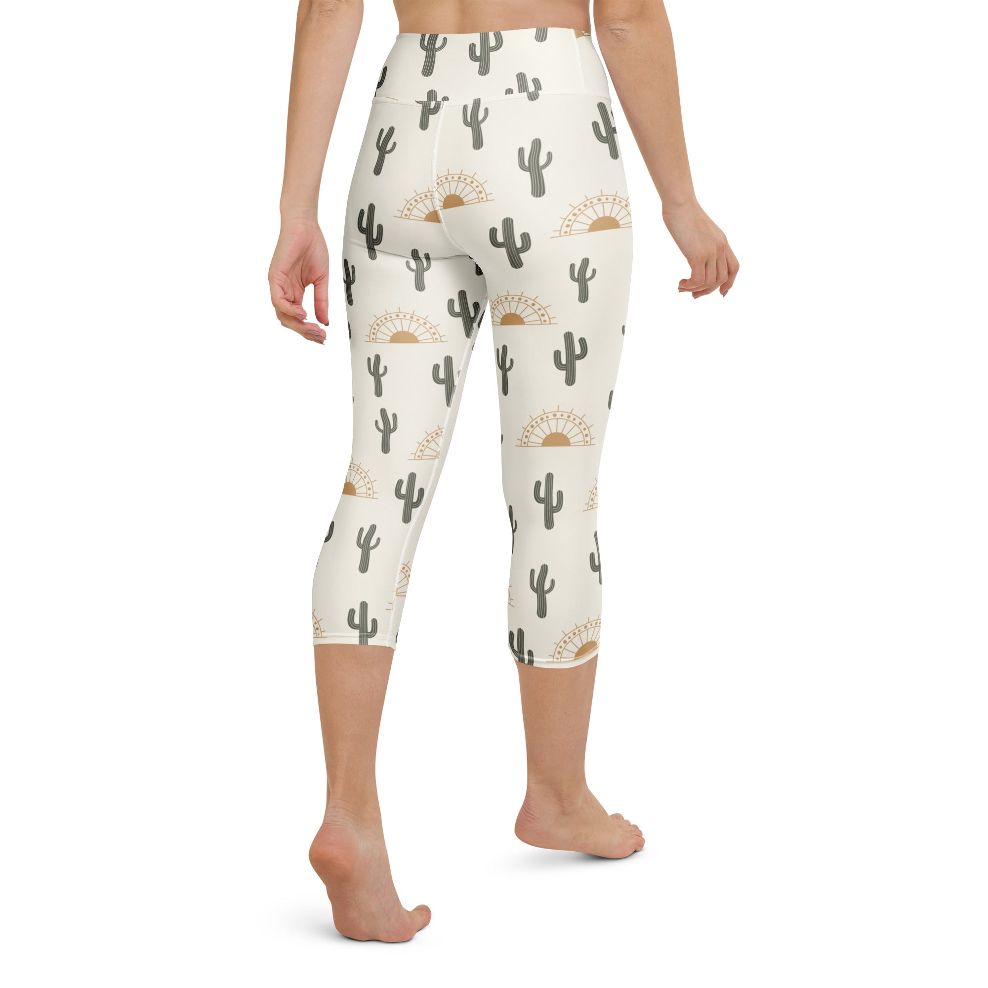 Cream-colored high-rise buttery soft yoga capri leggings with gray cactus and gold sunburst moisture-wicking pattern