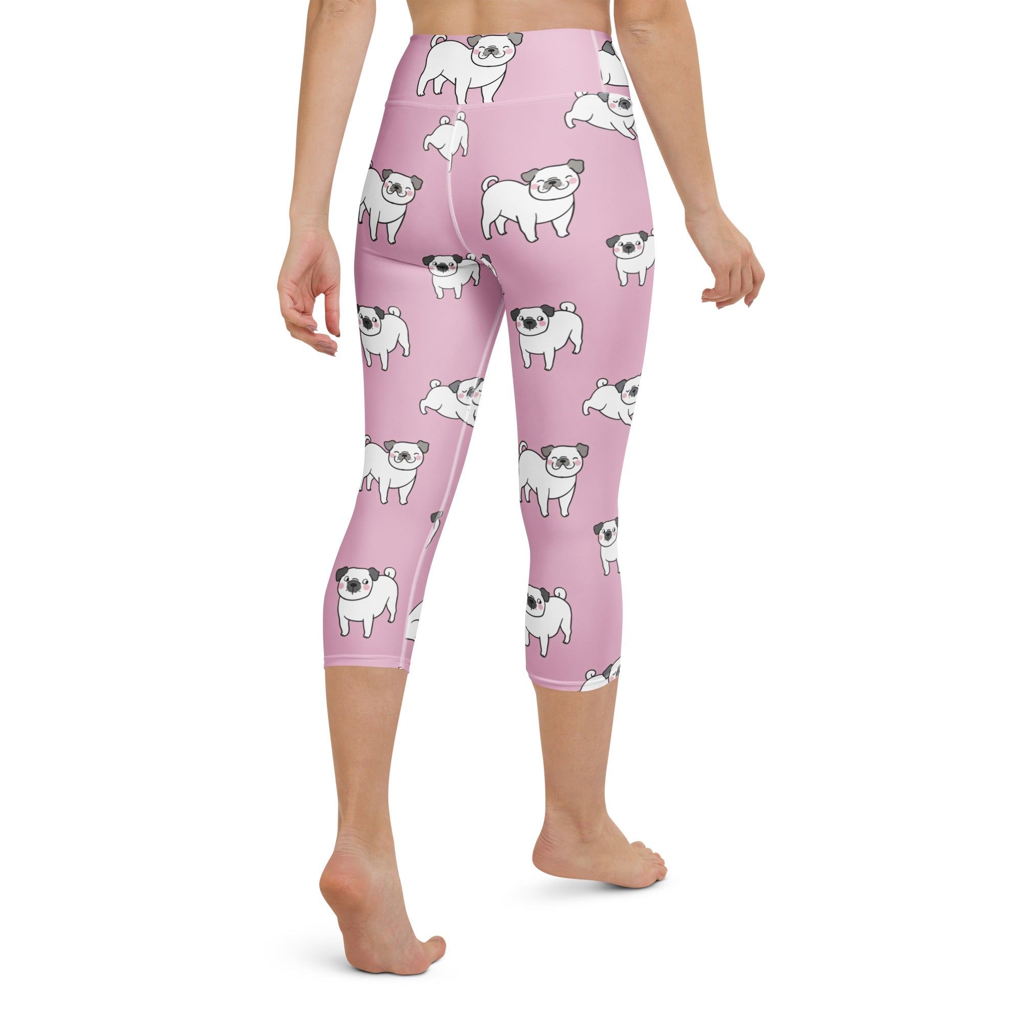 Women’s pink buttery soft high-rise capri leggings with white cartoon pug pattern moisture-wicking stretch