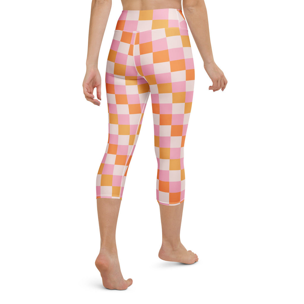 Women’s pink and orange checkered high-rise buttery soft yoga capri leggings with moisture-wicking stretch fabric