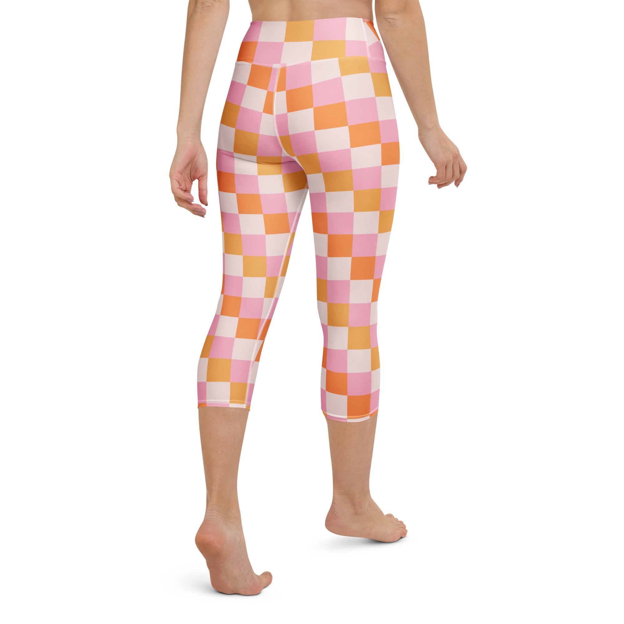 Women’s pink and orange checkered high-rise buttery soft yoga capri leggings with moisture-wicking stretch fabric