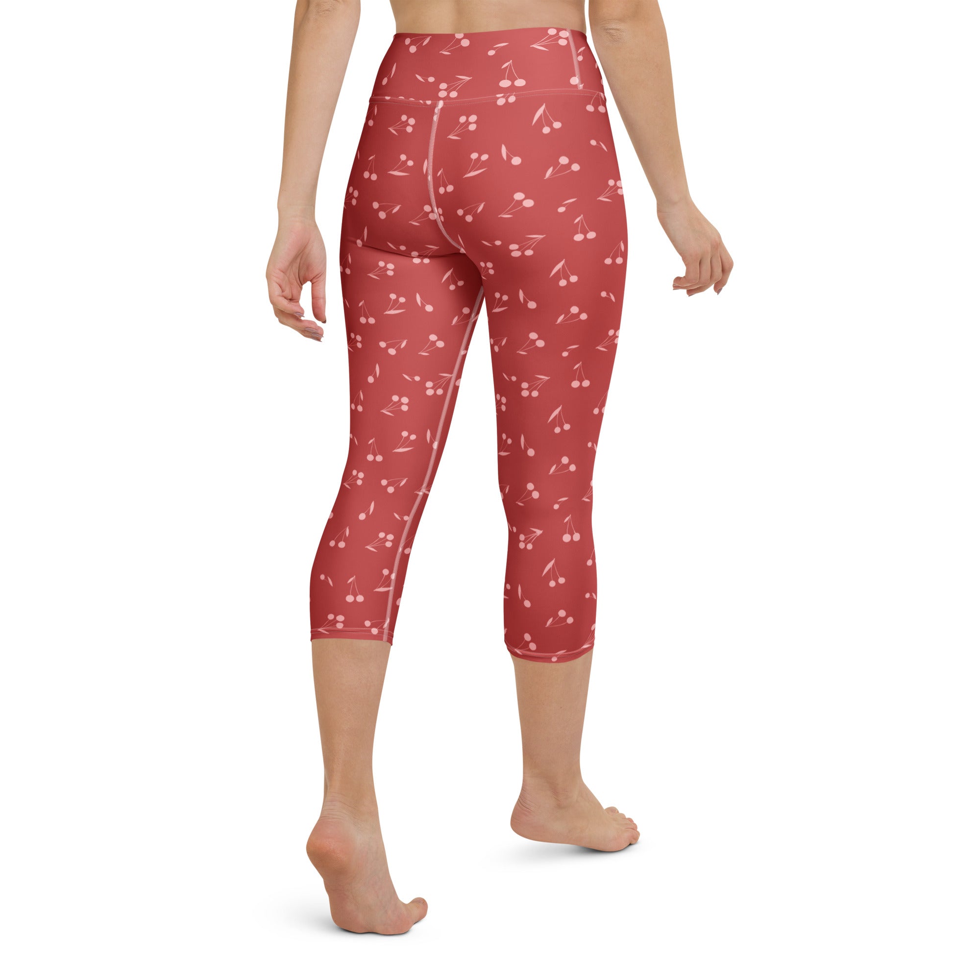 Women’s high-rise red cherry capri leggings made of buttery soft moisture-wicking stretch fabric for yoga