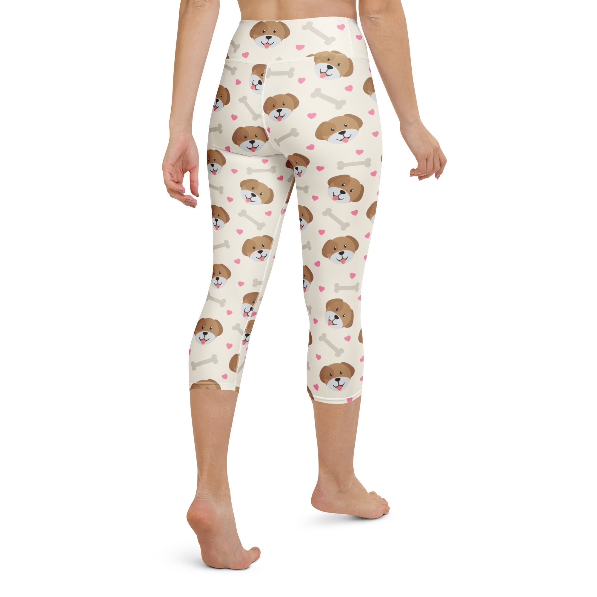 Cream-colored buttery soft high-rise moisture-wicking women’s yoga capri leggings with puppy faces pink hearts and bones pattern