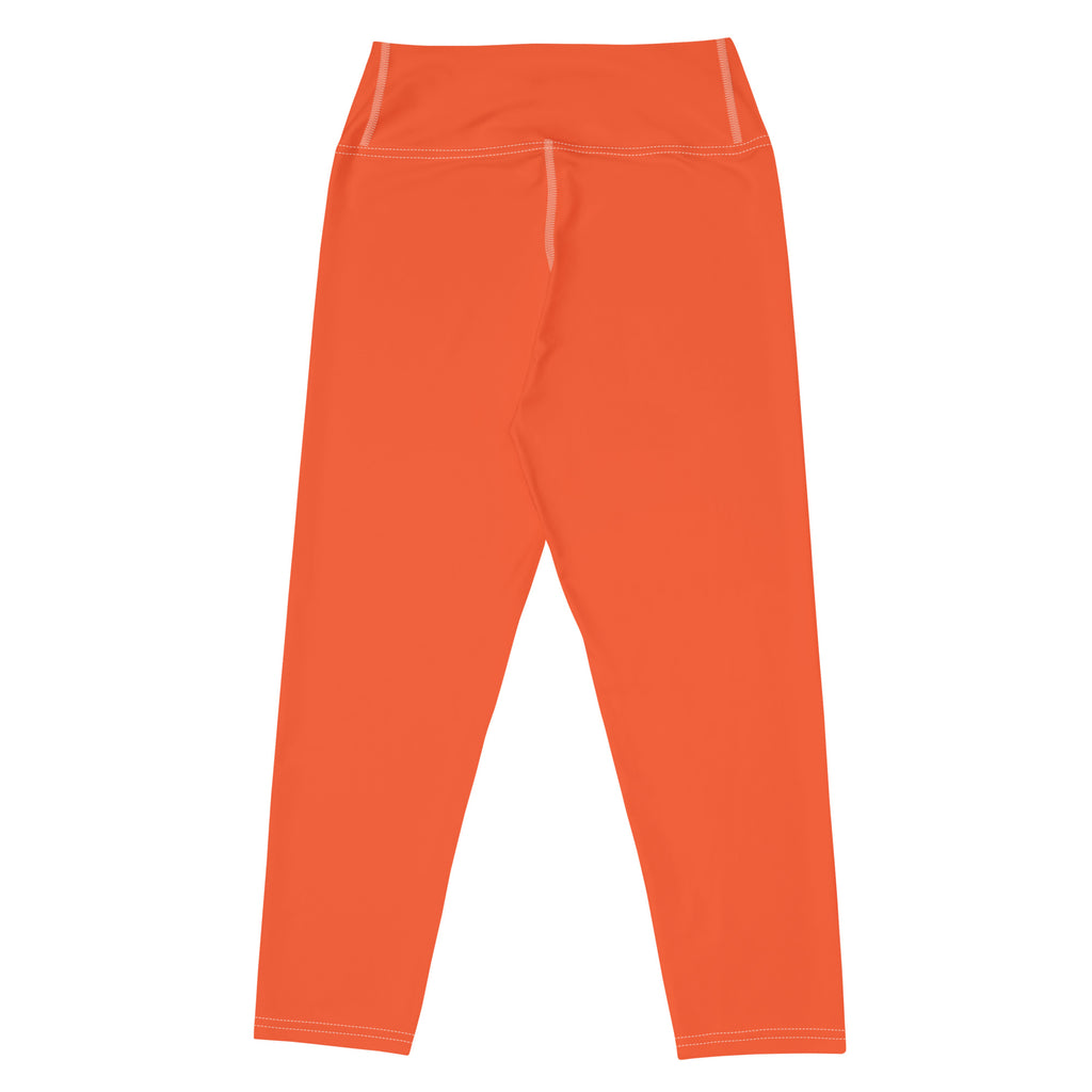 Bright orange high-rise buttery soft yoga capri leggings with matching stitching and moisture-wicking stretch fabric