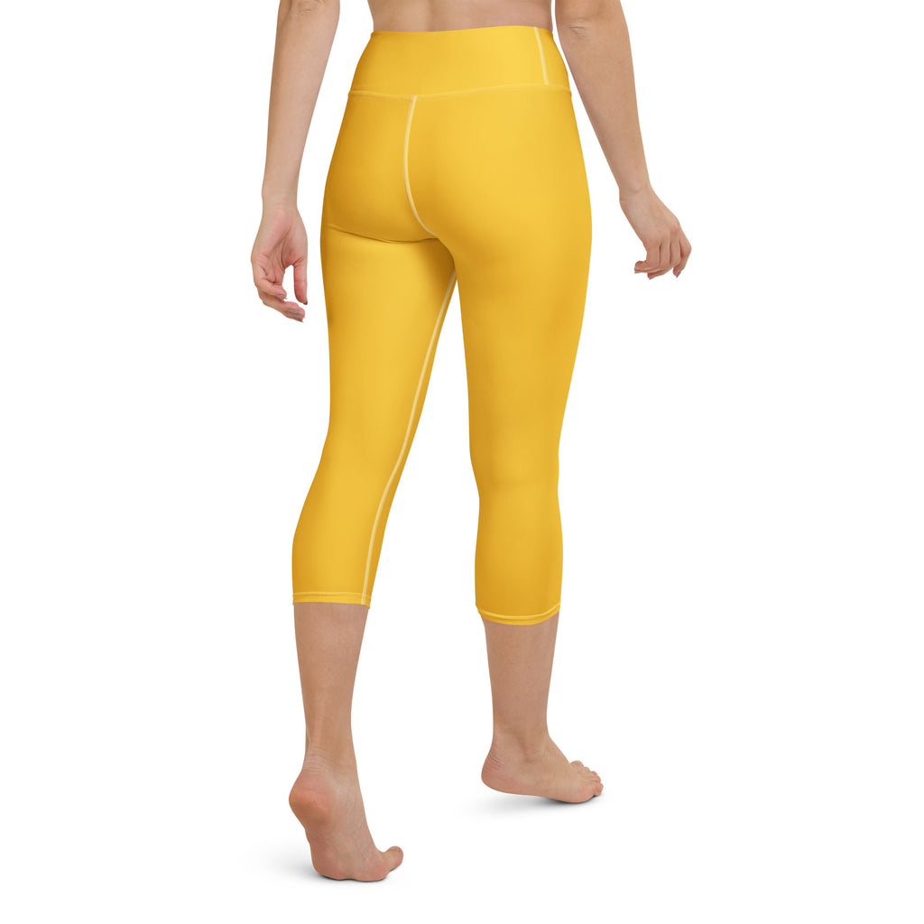 Women’s yellow buttery soft high-rise capri leggings with smooth stretchy fabric and subtle white seam detailing