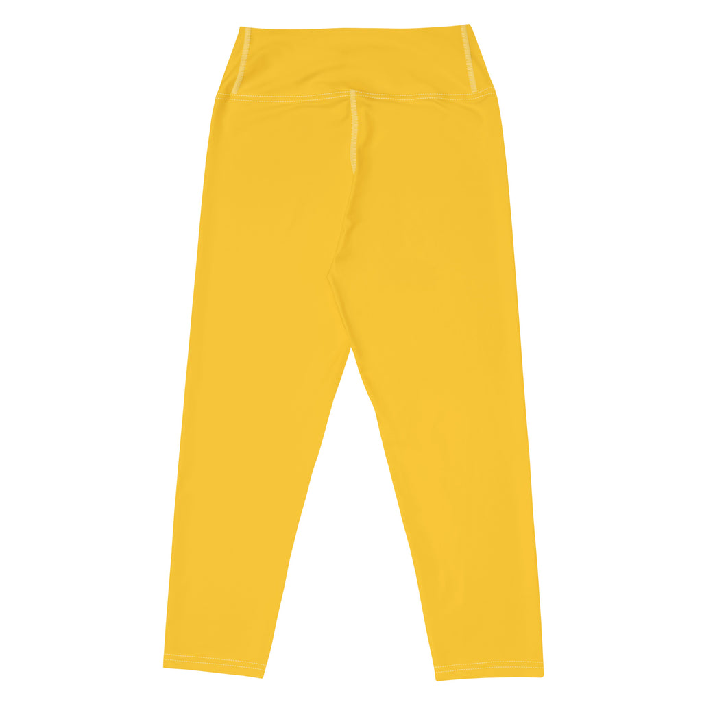 Bright yellow high-rise buttery soft yoga capri leggings made of stretchy moisture-wicking fabric for activewear