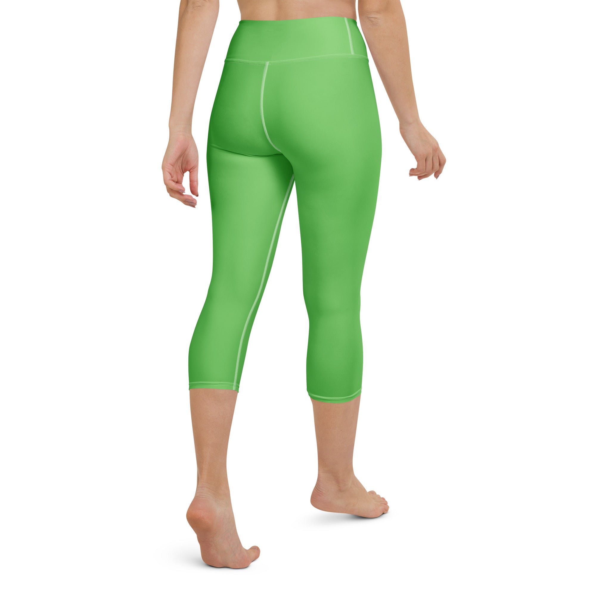 Women’s bright green buttery soft high-rise capri leggings with moisture-wicking fabric and subtle white seam stitching
