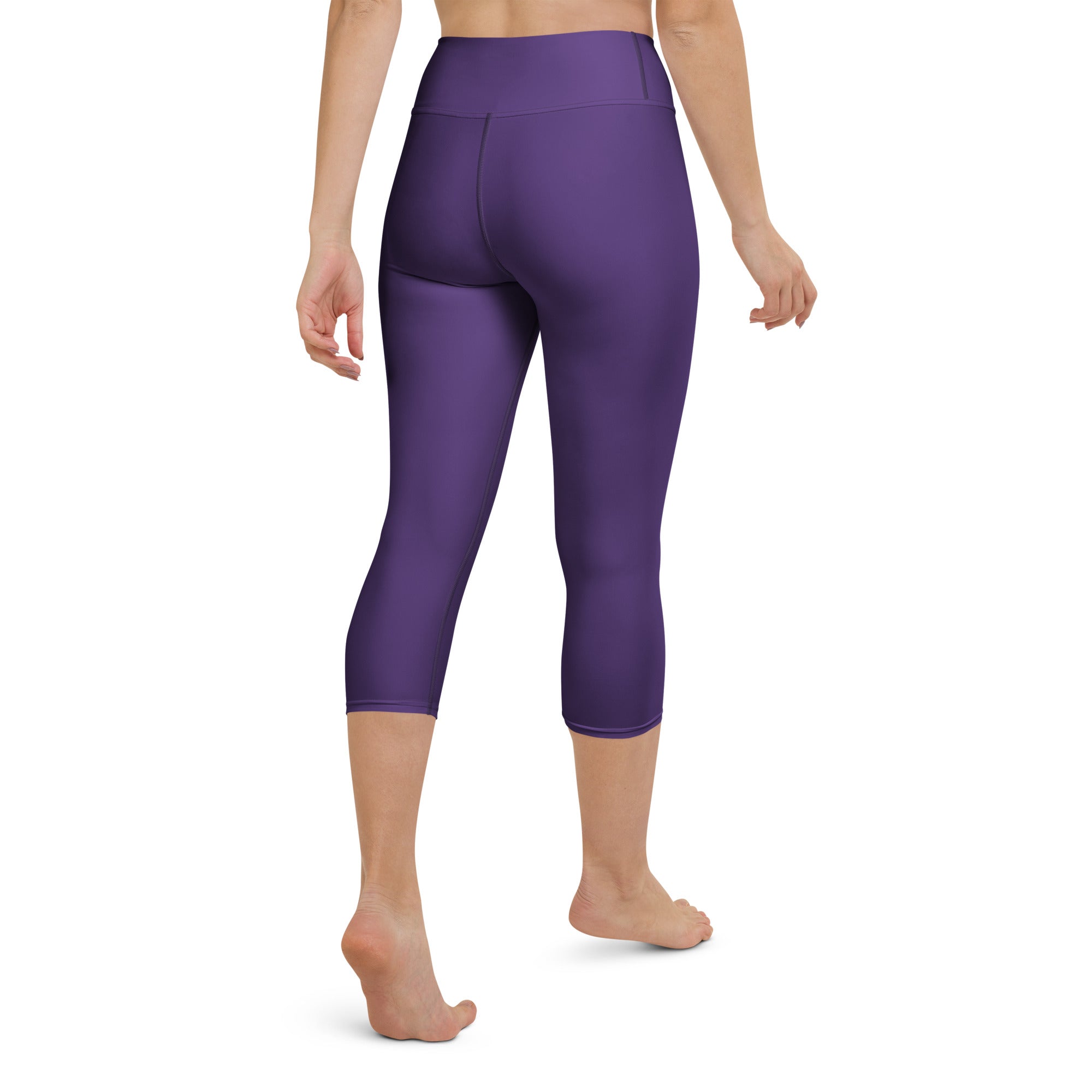 Purple high-waisted capri leggings made of smooth stretchy fabric for moisture-wicking yoga and activewear use