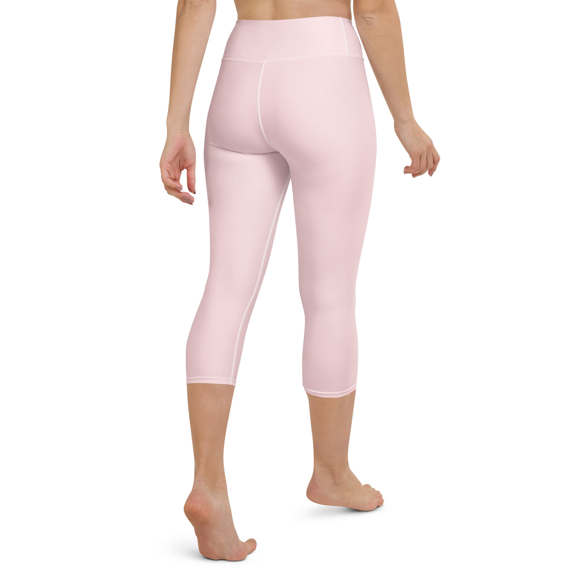 Women’s light pink buttery soft high-rise yoga capri leggings made of smooth stretchy moisture-wicking fabric