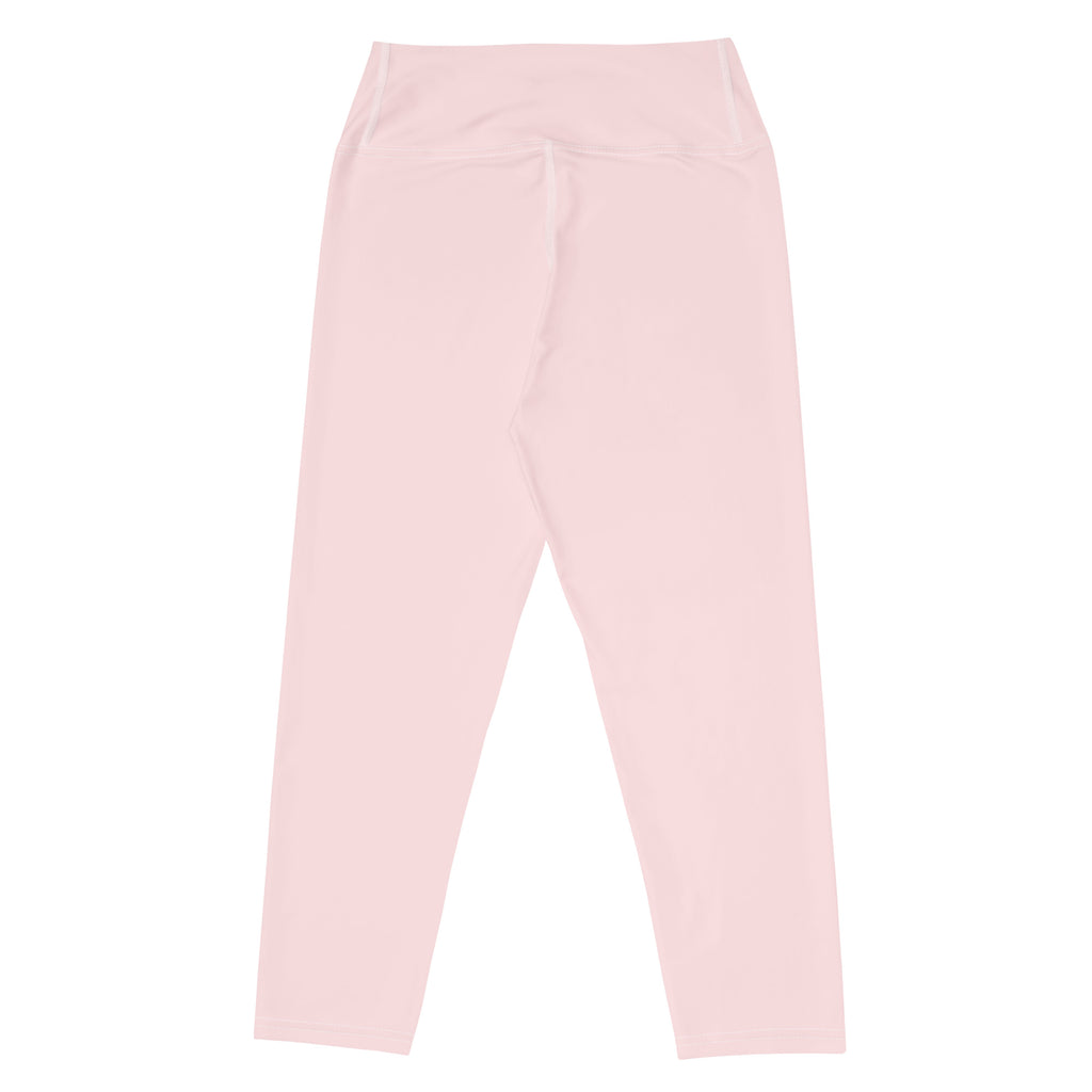 A pair of soft pink high-waisted buttery soft yoga capri leggings with smooth stretchy moisture-wicking fabric