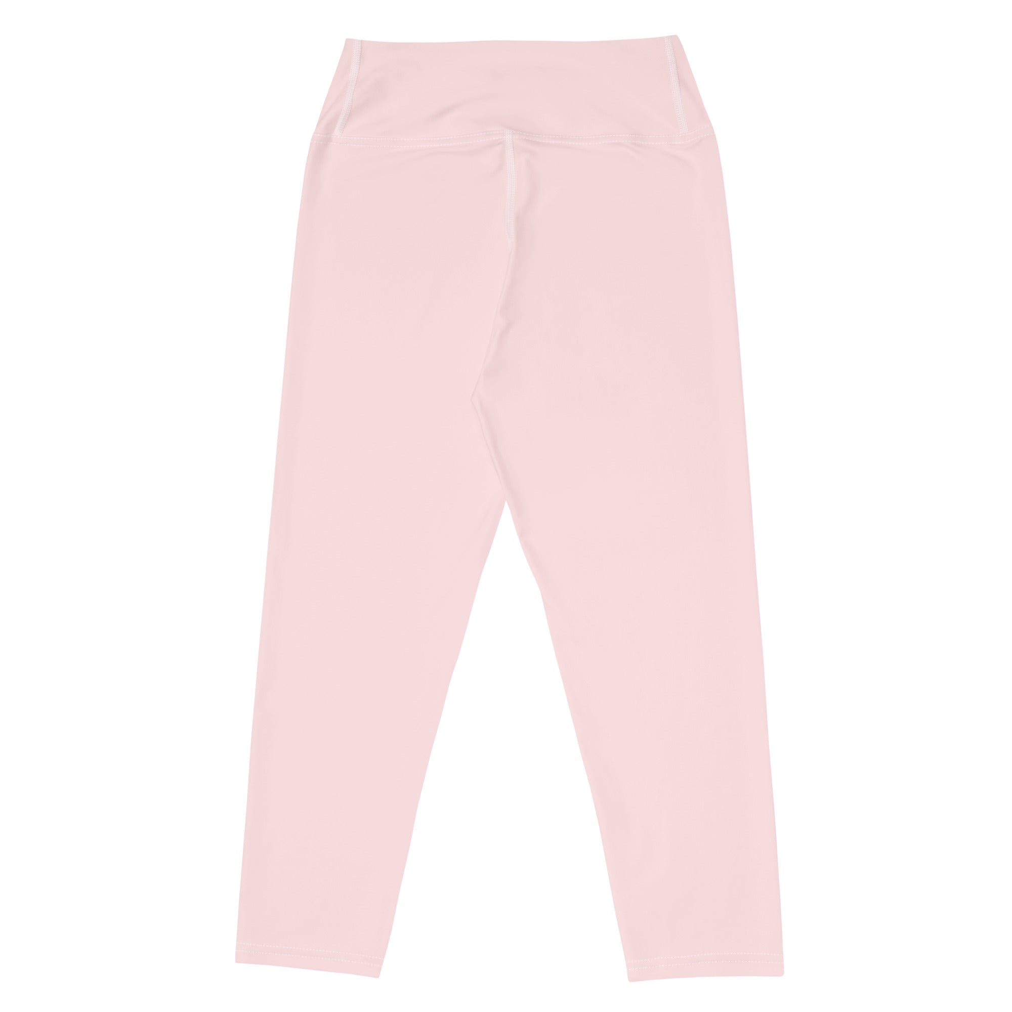 A pair of soft pink high-waisted buttery soft yoga capri leggings with smooth stretchy moisture-wicking fabric