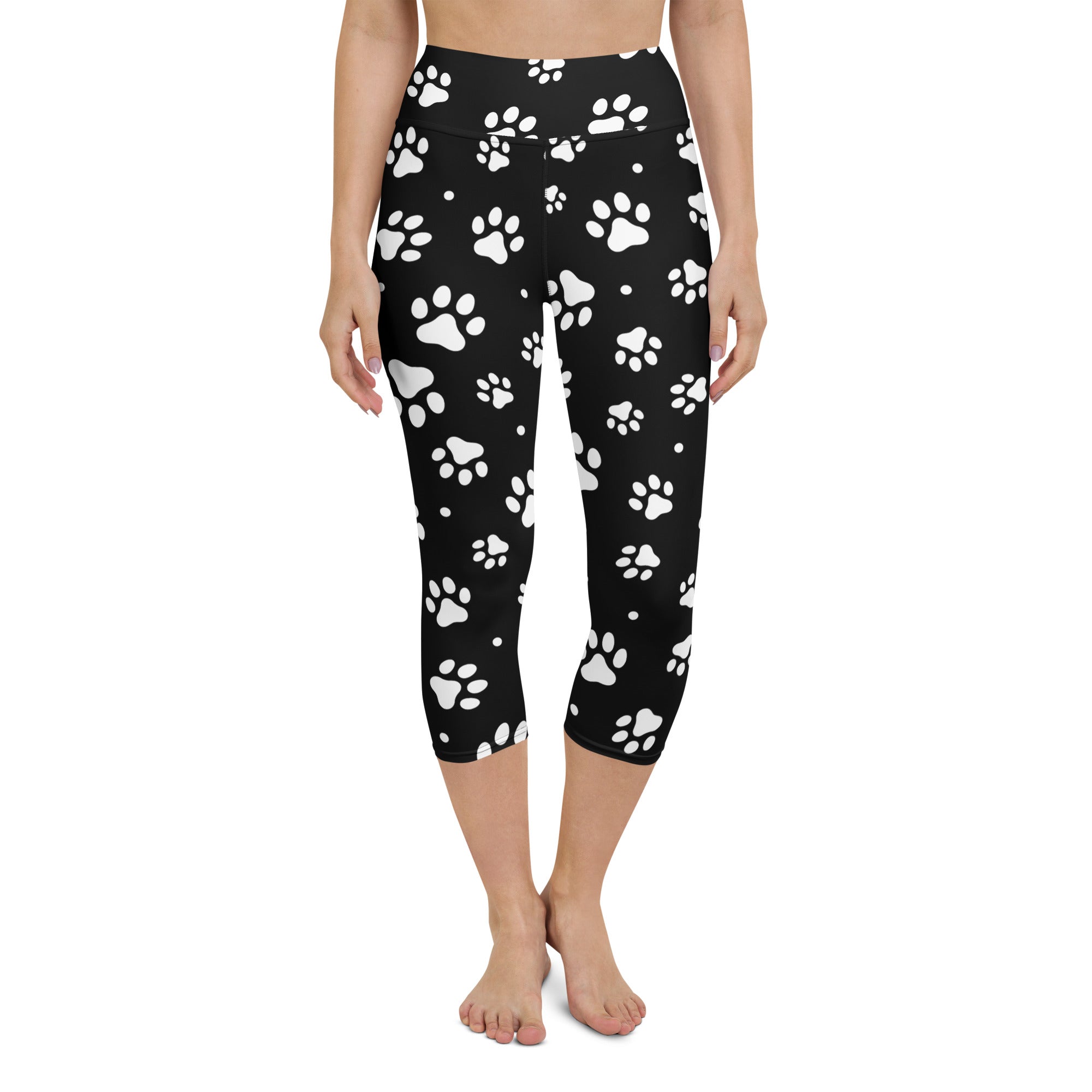 Black high-rise capri leggings with white paw print pattern made from buttery soft moisture-wicking stretch fabric