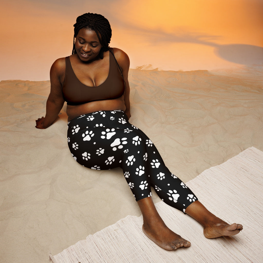 Black high-rise paw print buttery soft yoga capri leggings with white paw pattern and moisture-wicking stretch fabric