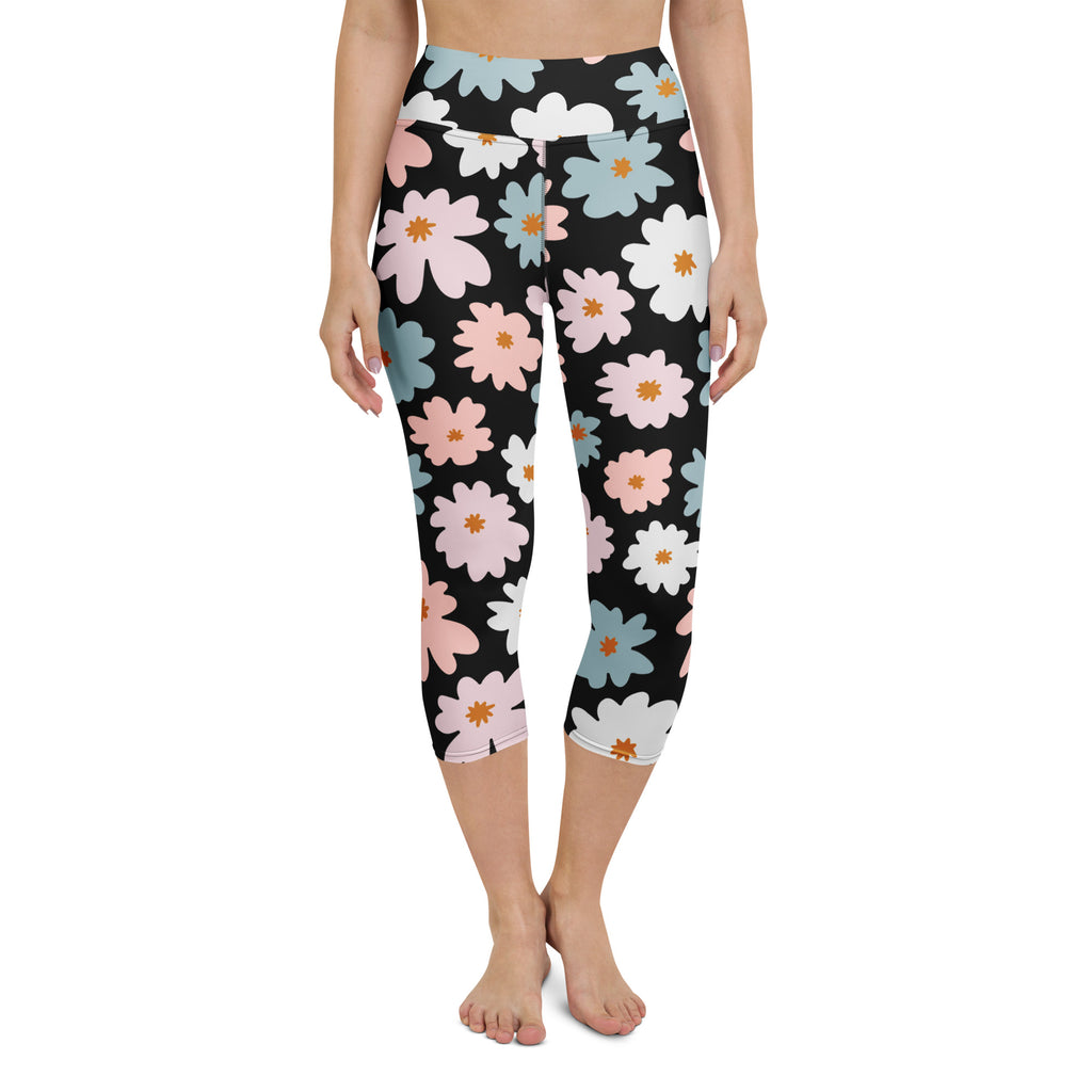Black capri leggings with pastel pink white and blue daisies featuring orange centers buttery soft high-rise activewear