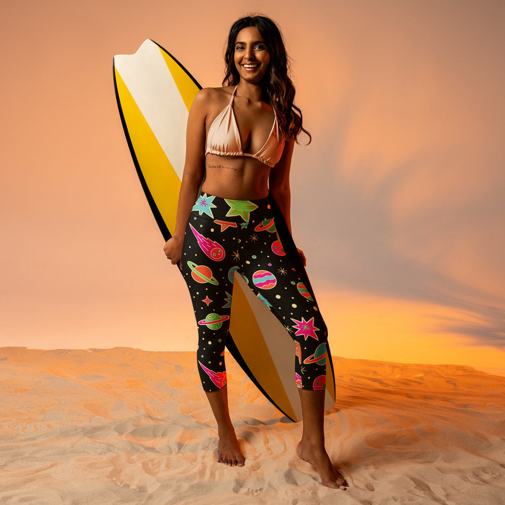 Women’s high-rise black capri leggings with vibrant cosmic planets stars rockets buttery soft moisture-wicking fabric
