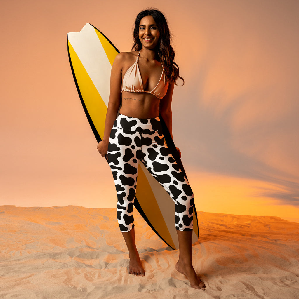 Women’s cow print buttery soft high-rise yoga capri leggings in black and white moisture-wicking stretch fabric