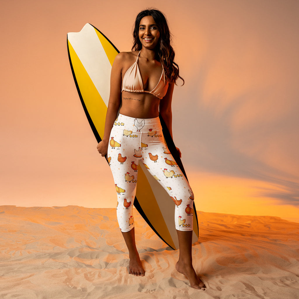 White high-rise moisture-wicking yoga capri leggings with soft stretch fabric and playful multicolor cartoon chicken pattern