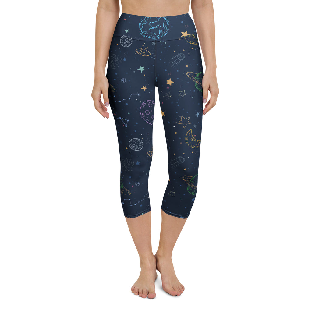Dark blue high-rise buttery soft capri leggings with pastel space-themed planets stars and rockets print for yoga