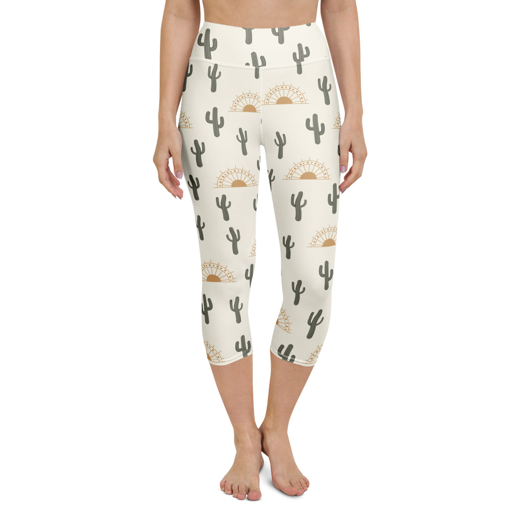 Cream-colored high-rise buttery soft yoga capri leggings with gray cactus and golden sunset pattern for activewear