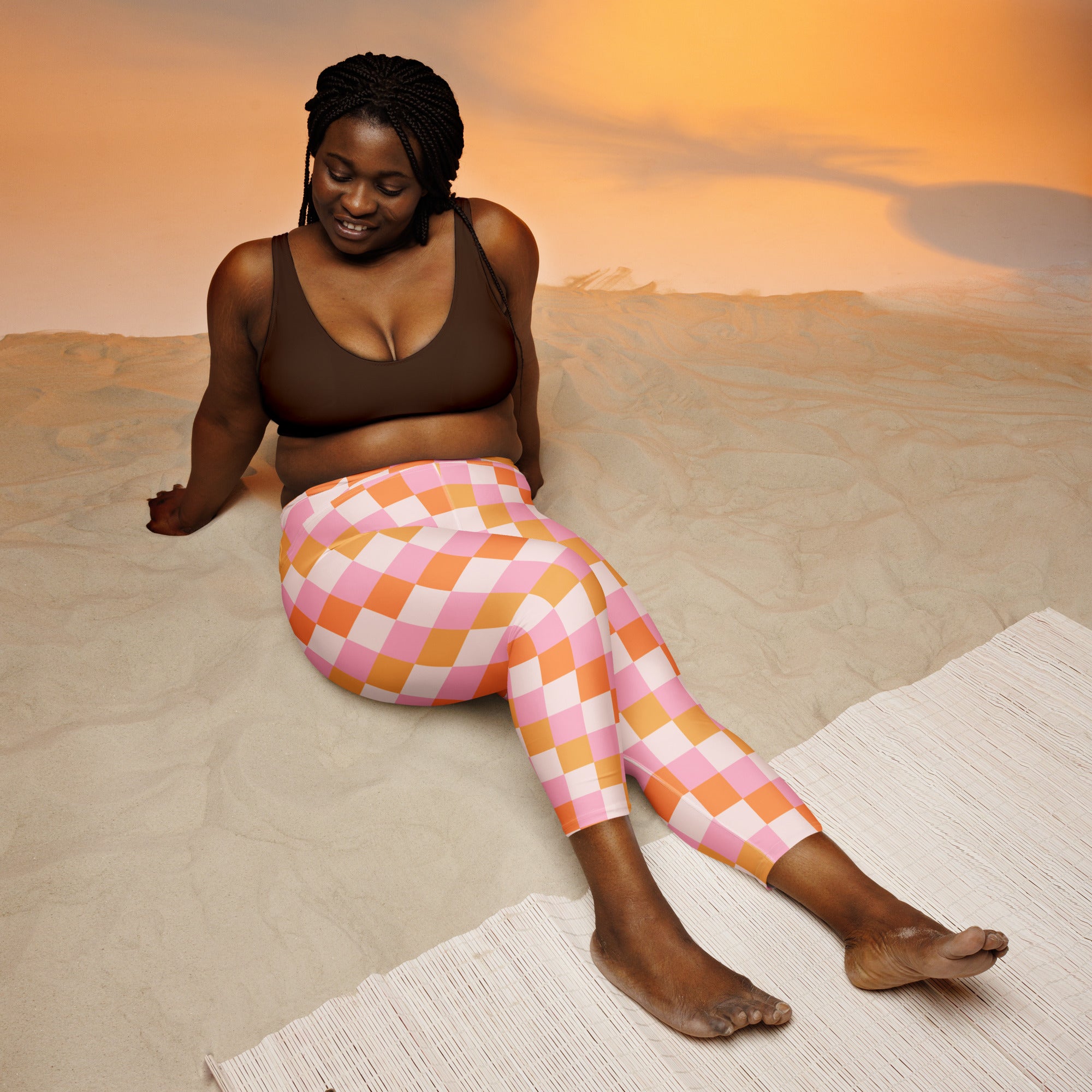 Women’s pink and orange checkered high-rise buttery soft yoga capri leggings with moisture-wicking stretch fabric