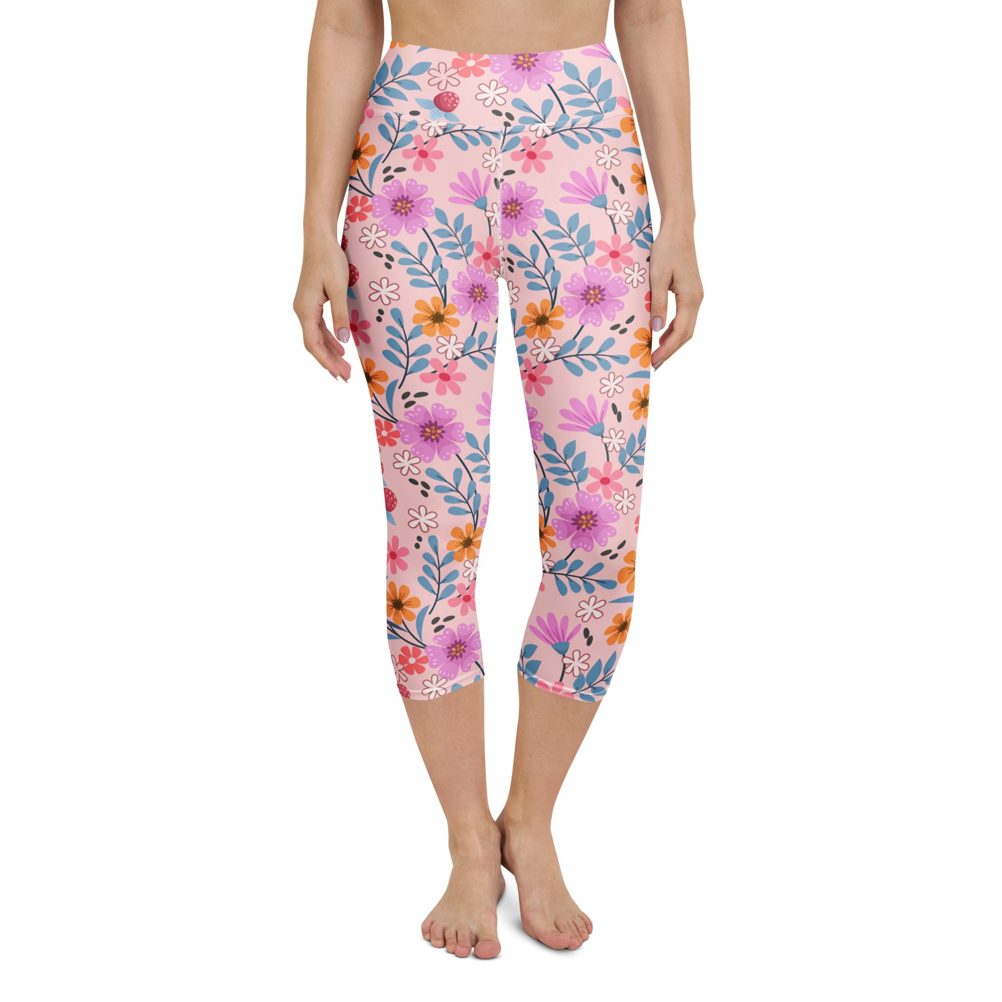 Women’s pink floral buttery soft high-rise yoga capri leggings with vibrant purple orange and blue flowers on light pink