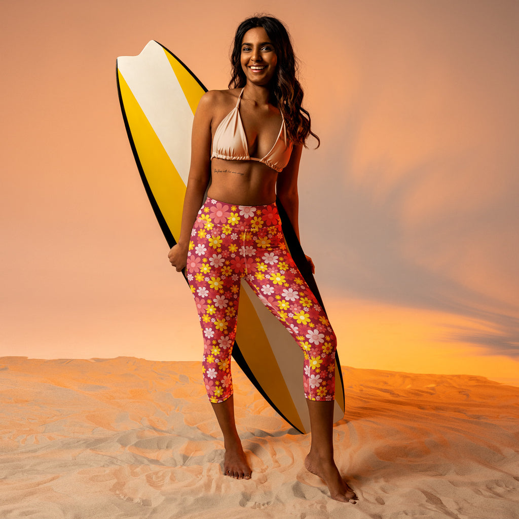 Women’s red floral buttery soft high-rise capri leggings with moisture-wicking stretch worn by woman holding surfboard
