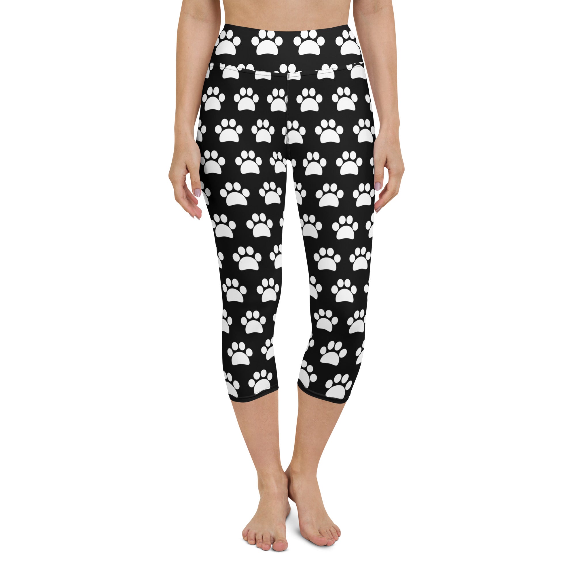 Women’s black buttery soft high-rise yoga capri leggings with white paw print pattern and moisture-wicking fabric