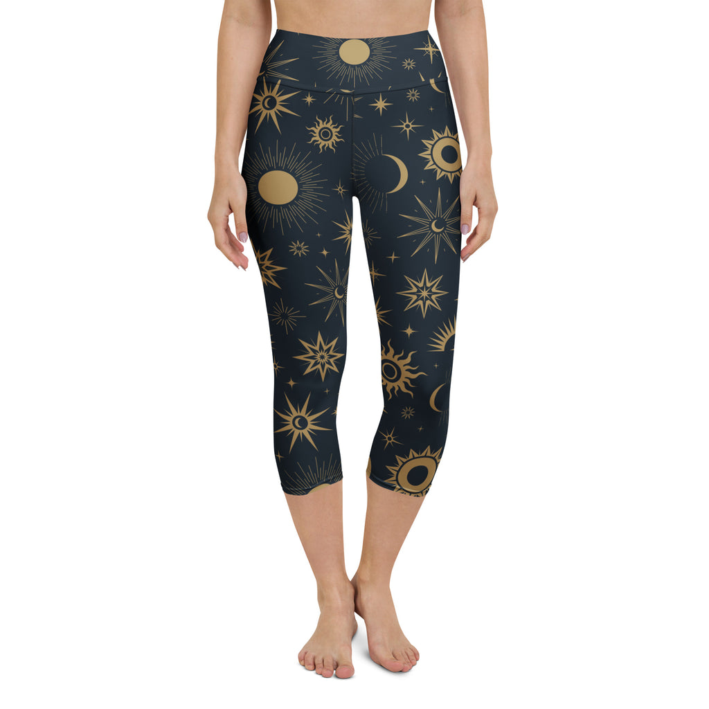 Dark blue high-rise celestial yoga capri leggings with gold suns moons stars buttery soft moisture-wicking fabric