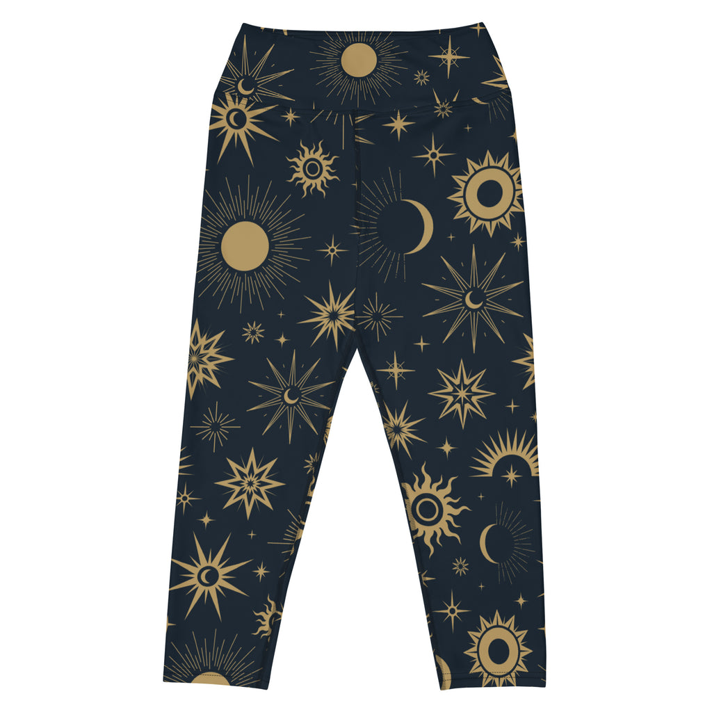 Dark blue buttery soft high-rise yoga capri leggings with celestial gold suns moons and stars pattern for activewear