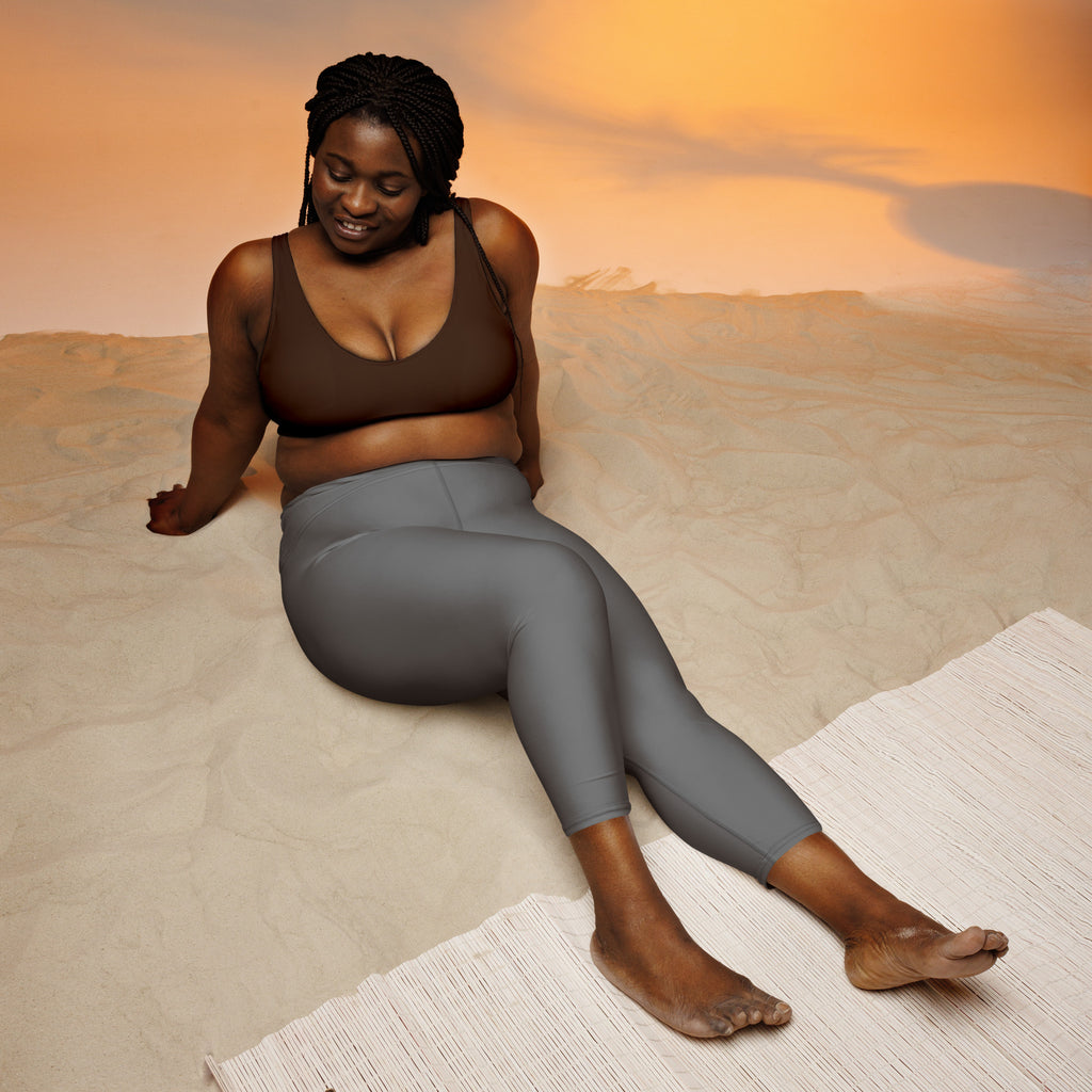 A woman wearing a brown sports bra and women’s gray buttery soft high-rise moisture-wicking yoga capri leggings