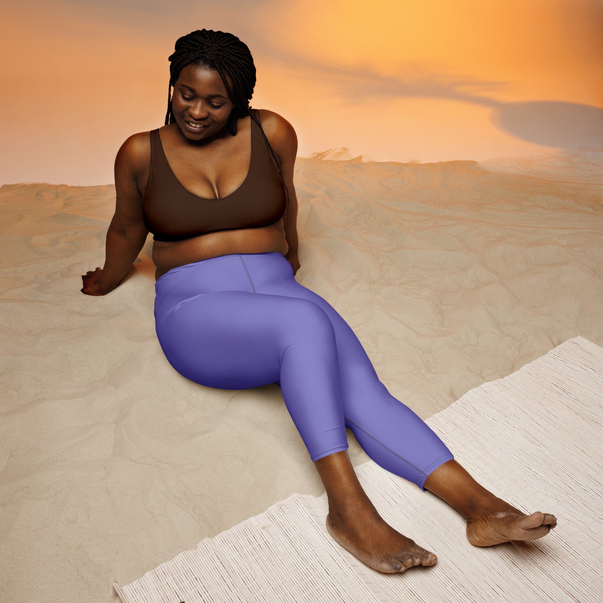 A pair of vibrant purple high-rise capri leggings with buttery soft stretchy fabric for yoga and activewear
