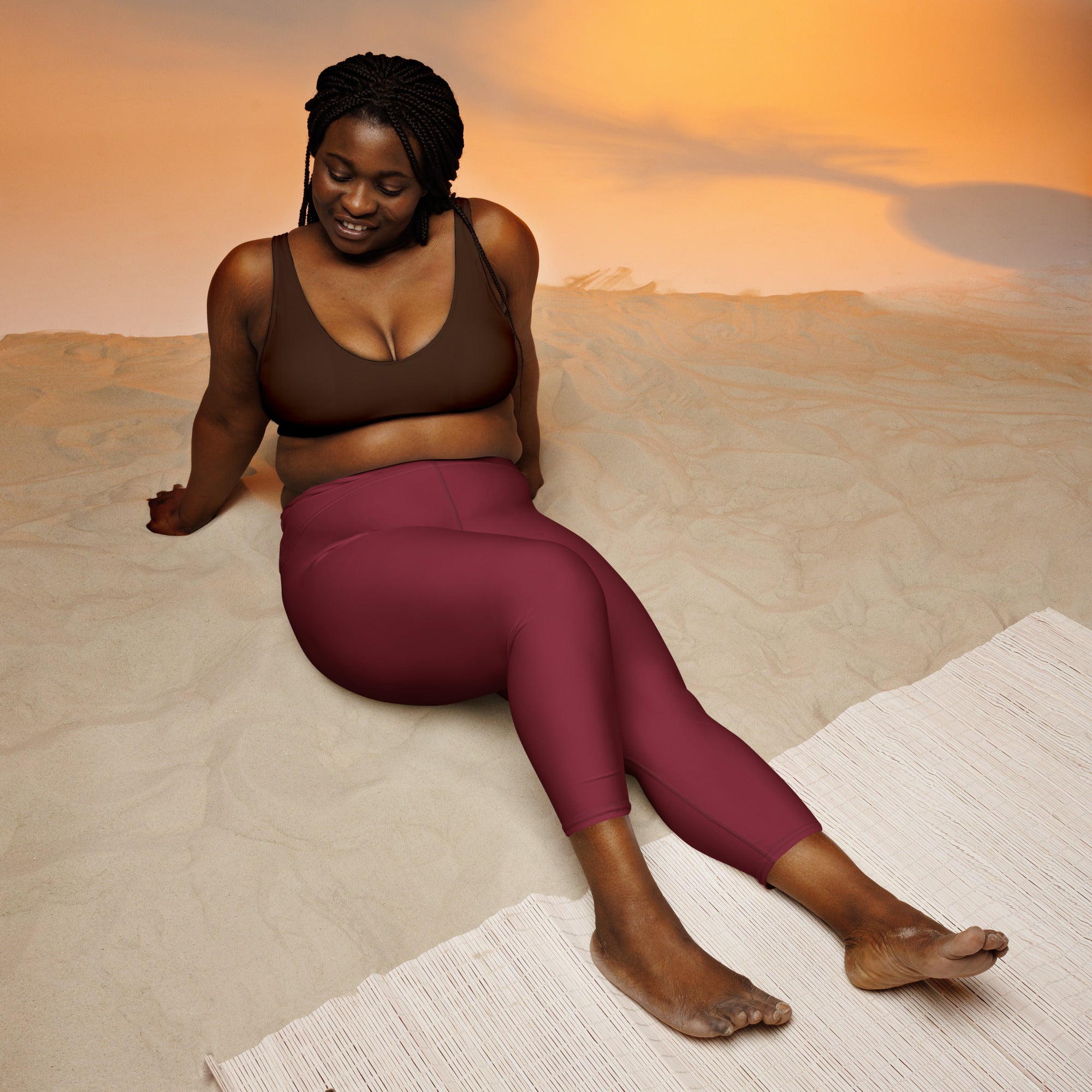 A woman wearing women’s burgundy high-rise buttery soft yoga capri leggings with moisture-wicking stretch fabric