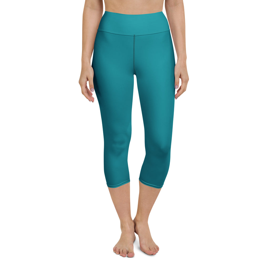 Women’s teal high-rise buttery soft yoga capri leggings made of moisture-wicking stretchy fabric shown from the back
