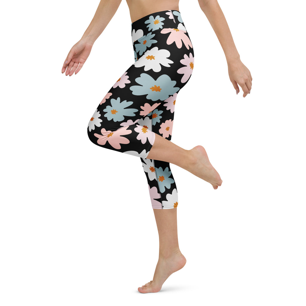 Women’s retro floral buttery soft black capri leggings with pink white light blue daisies and orange centers, high-rise moisture-wicking activewear