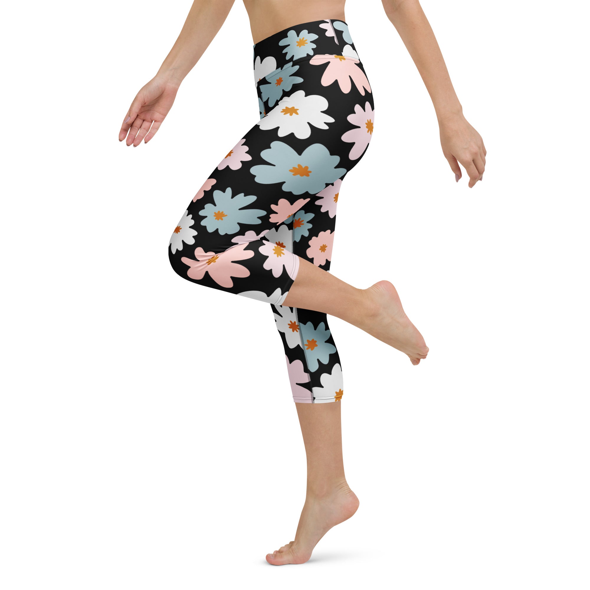 Women’s retro floral buttery soft black capri leggings with pink white light blue daisies and orange centers, high-rise moisture-wicking activewear