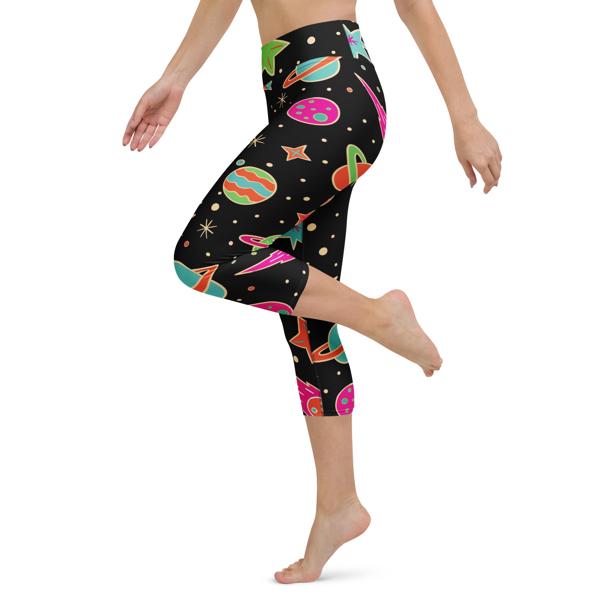 Black capri leggings with vibrant space-themed pattern of colorful planets stars and rockets high-rise moisture-wicking