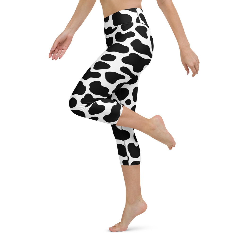 Women’s high-rise black and white cow print buttery soft moisture-wicking yoga capri leggings front view