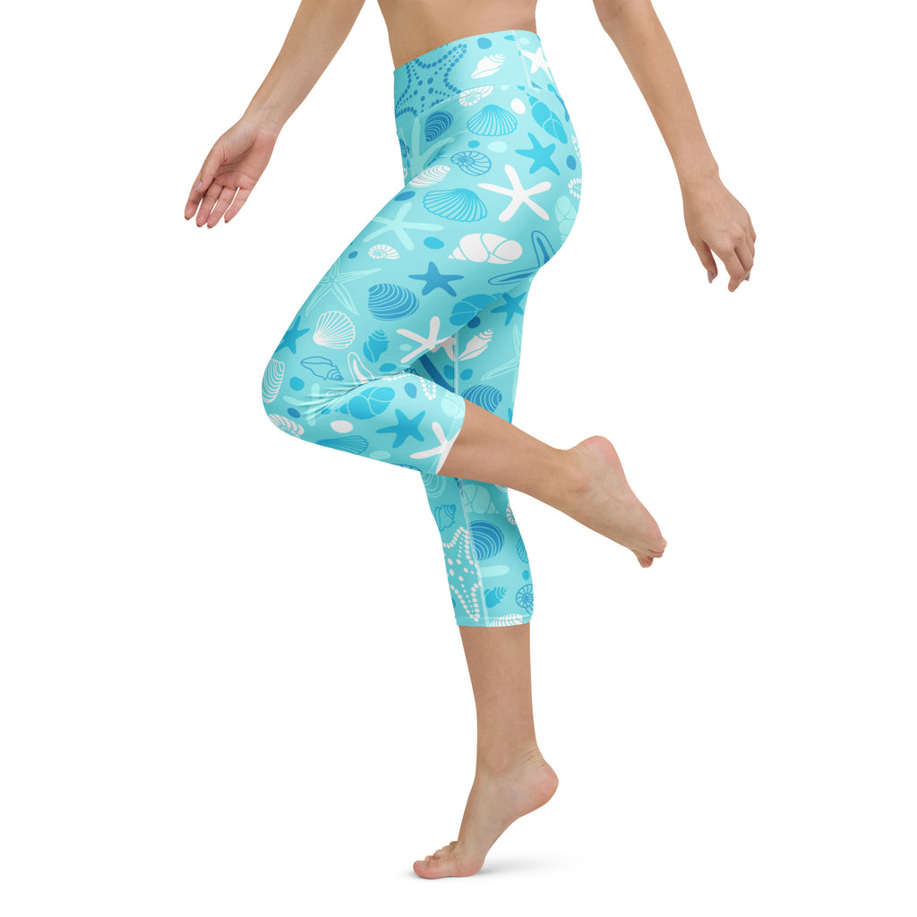 Light blue high-rise buttery soft women’s yoga capri leggings with white and dark blue seashells and starfish pattern