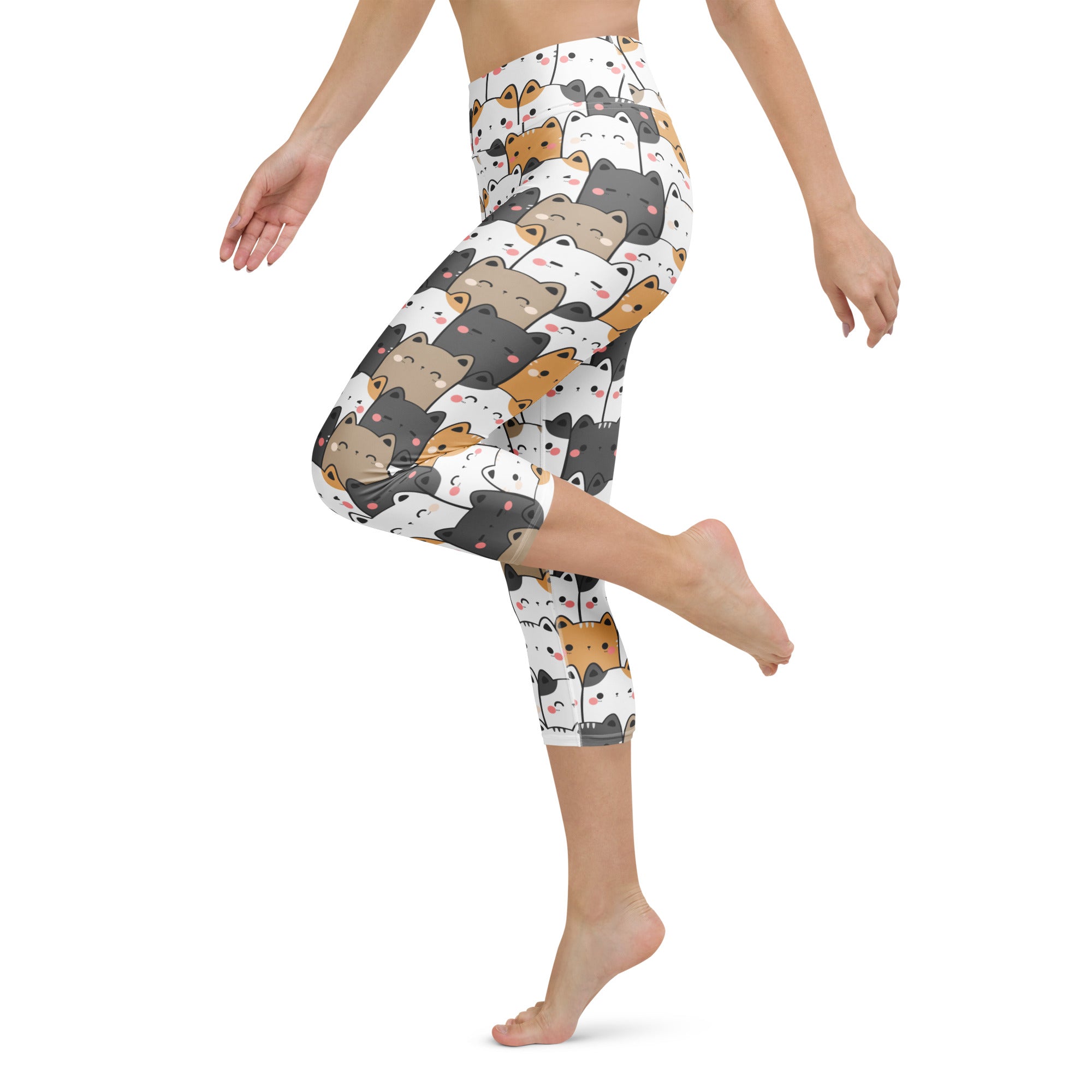 White capri leggings with kawaii cartoon cats in black brown and orange featuring a buttery soft high rise fit