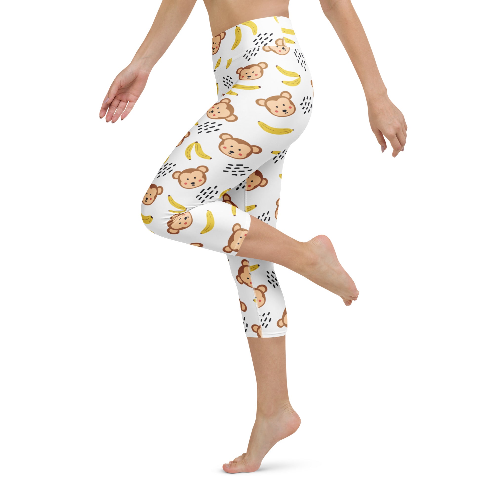 White high-rise capri leggings with brown cartoon monkeys yellow bananas black dotted accents soft stretch activewear