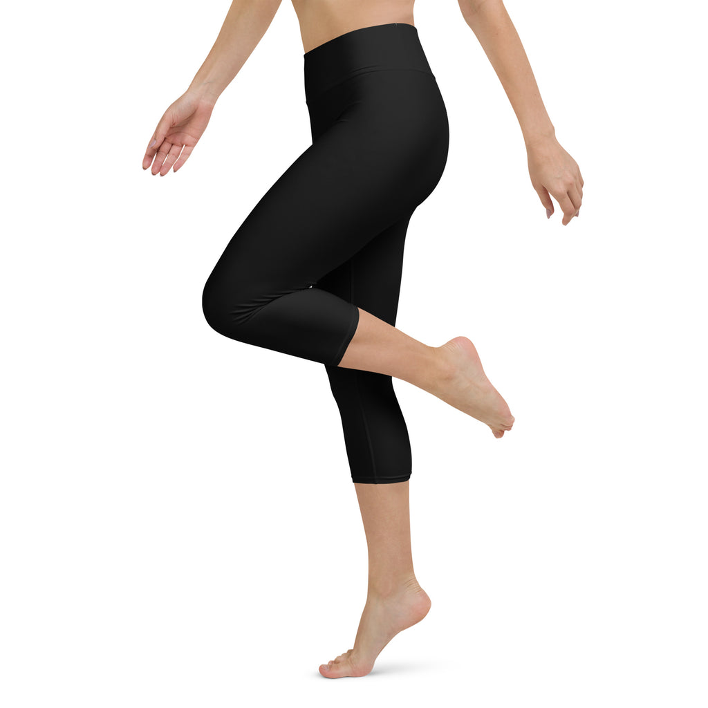 Women’s black buttery soft high-rise yoga capri leggings with moisture-wicking soft stretch fabric shown from the back
